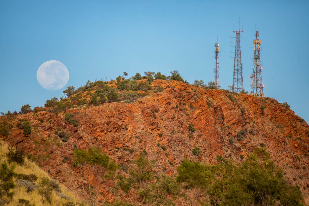 Mt Gillen at Alice Springs with a full moon setting in the background