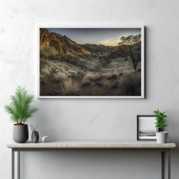 Journey into the heart of the MacDonnell Ranges with this panoramic capture. The image presents a richly textured terrain, unfolding into the untamed wilderness under the vast open sky. This outdoor spectacle is more than just a landscape—it's a testimony to the raw grandeur of nature and the enchanting beauty of the Australian outback. Let this sweeping vista transport you into the heart of the wild, immersing you in the serene rhythm of the great outdoors.