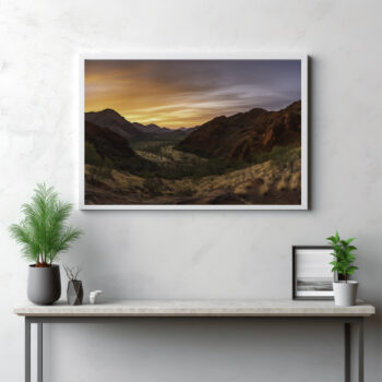 Delve into the striking beauty of the MacDonnell Ranges with this panoramic depiction. The image presents a comprehensive view of the landscape, revealing an intricate tapestry woven from rugged mountains, expansive valleys, and unspoiled wilderness. It's a captivating celebration of the outdoors where the natural splendor of the Australian outback unfolds before your eyes. This isn't just a view—it's an immersive journey into the heart of nature's grandeur.