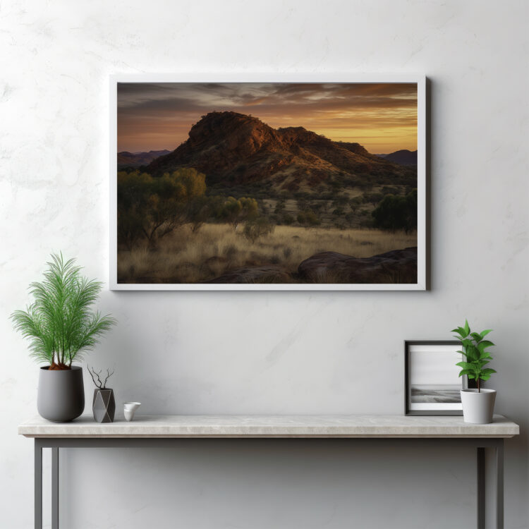 Embark on a breathtaking journey into the heart of the MacDonnell Ranges with this captivating depiction. The image offers a panoramic vista of the rugged mountain range, revealing an array of majestic peaks reaching into the wilderness sky. This visual testament to nature's grandeur showcases the untouched beauty of the outdoors, and the austere splendor of this iconic Australian landscape. It's not merely a scenery, but a symphony of natural elements etching an enduring testament to the timelessness of the wild.