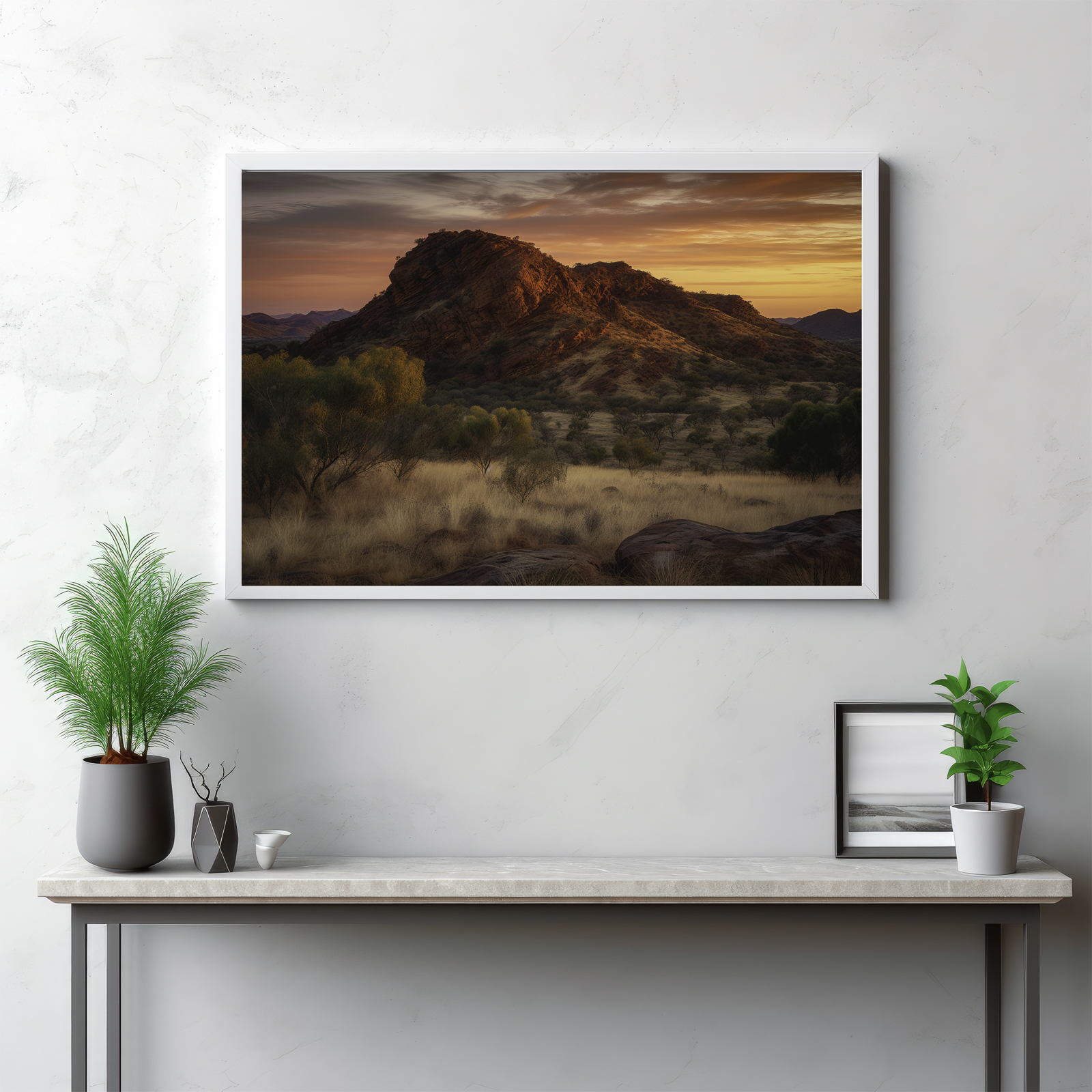 Embark on a breathtaking journey into the heart of the MacDonnell Ranges with this captivating depiction. The image offers a panoramic vista of the rugged mountain range, revealing an array of majestic peaks reaching into the wilderness sky. This visual testament to nature's grandeur showcases the untouched beauty of the outdoors, and the austere splendor of this iconic Australian landscape. It's not merely a scenery, but a symphony of natural elements etching an enduring testament to the timelessness of the wild.