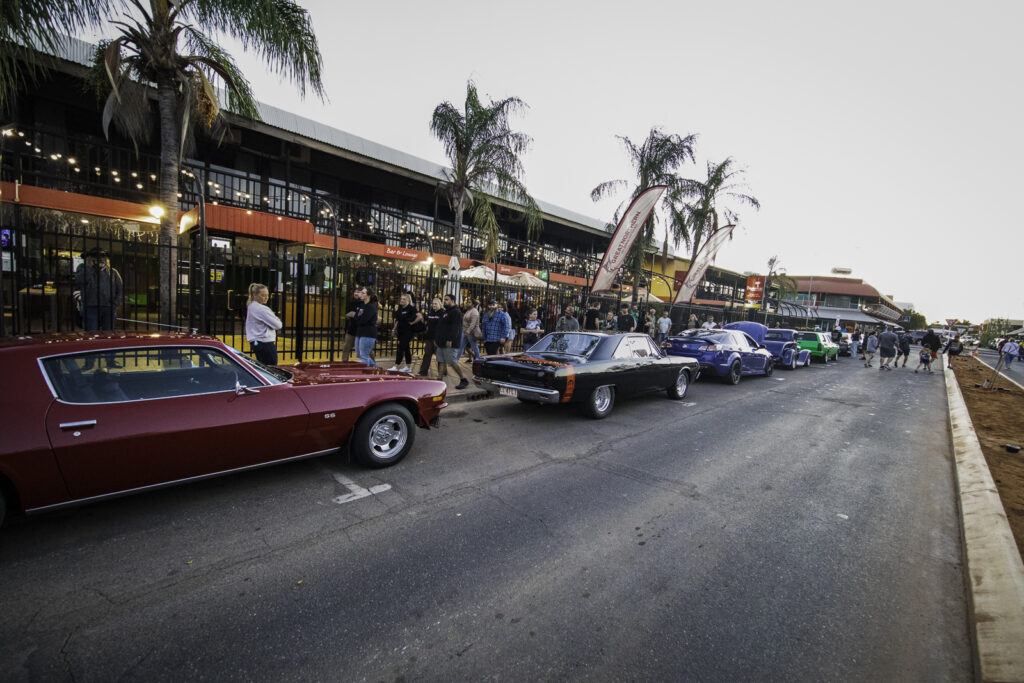 A panoramic shot of the bustling atmosphere at the Fringe Festival, showcasing vibrant colors and energetic festival-goers.