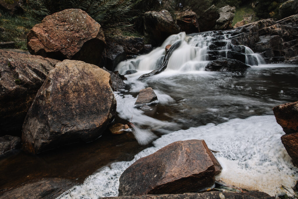 Discover the tranquil beauty of MacKenzie Falls in Victoria, Australia. This vivid image located a short distance from the falls captures the essence of nature with its glistening waters cascading down rugged rocks, accompanied by the gentle symphony of the stream. A true haven for outdoor enthusiasts and a masterpiece of Mother Nature's work.